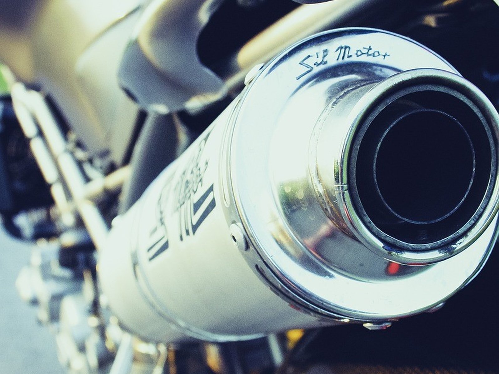 Chromowany układ wydechowy motocykla z bliska, to w nim siedzi katalizator i sonda lambda